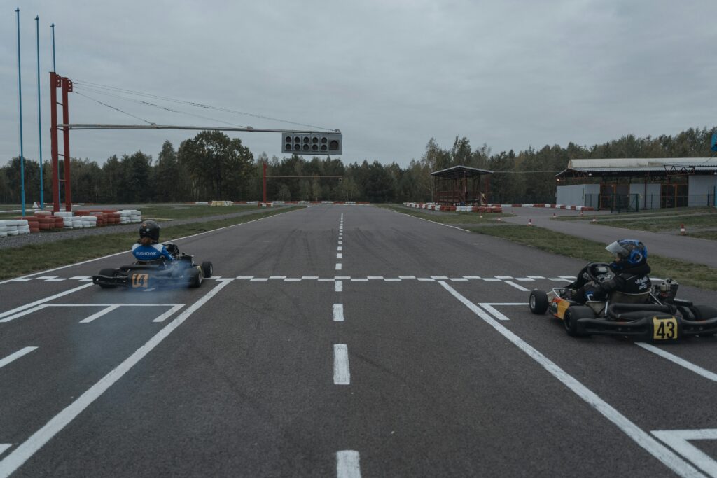 Exciting finish in a go-kart race at an outdoor track, showcasing intense motorsport action.