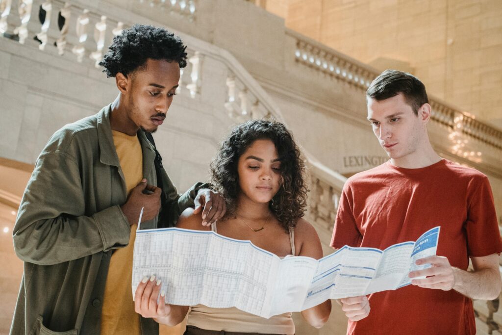 Group of travelers reading a map in Grand Central Station, New York City.